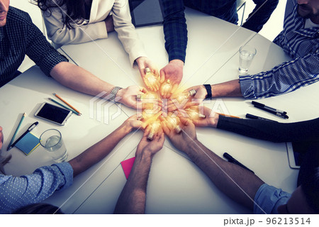 Teamwork and brainstorming concept with businessmen that share an idea with a lamp. Concept of startup 96213514
