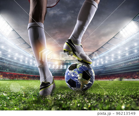 Player with a soccer ball a as world. Earth provided by NASA. 96213549