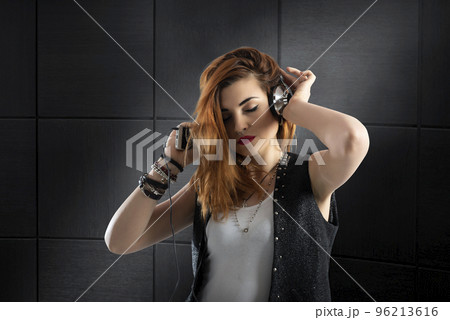Dancing girl listens to music with headset Dancing girl listens to music with headset 96213616
