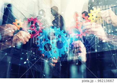 Working group of businessmen find the agreement by holding a piece of gear in hand. concept of teamwork and business partnership. double exposure 96213667