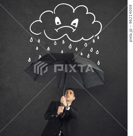 Businessman with umbrella and a angry cloud with rain. Concept of crisis and financial trouble 96214009