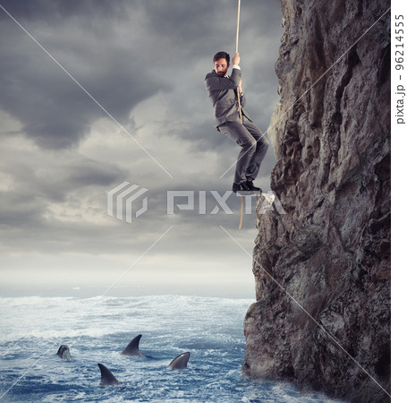 Businessman is likely to fall into the sea with sharks. concept of problems and difficulty in business 96214555