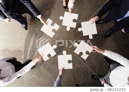 Teamwork of partners. Concept of integration and startup with puzzle pieces Teamwork of partners. Concept of integration and startup with puzzle pieces 96215225