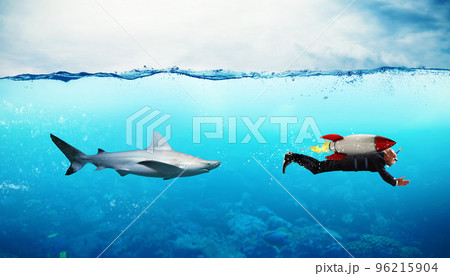 Concept of competition. Businessman escapes from sharks with a rocket Concept of competition. Businessman escapes from sharks with a rocket 96215904