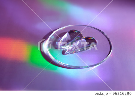 Smear of gel cosmetics product in petri dish on holographic background with iridescent highlights Smear of gel cosmetics product in petri dish on holographic background with iridescent highlights 96216290
