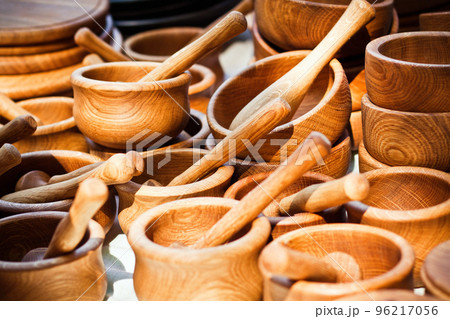 Handmade wooden mortars and pestles on a market stall 96217056