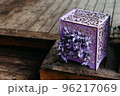 purple open gift box on wooden floor 96217069