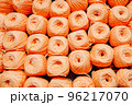 orange woolen threads in a ball for knitting close-up 96217070