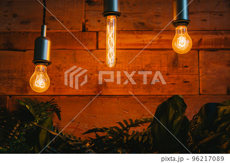 Vintage Edison lamps in a glass bulb with a tungsten filament inside on a dark background 96217089