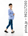 Asian boy 10 years old in casual blazer walking smart and happily looking at camera on isolated white background 96217260