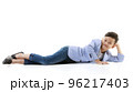 A 10-year-old Asian boy in a casual jacket is lying on the floor and smiling happily in a good mood looking at the camera. Positive concepts for children and young men's lifestyles. 96217403