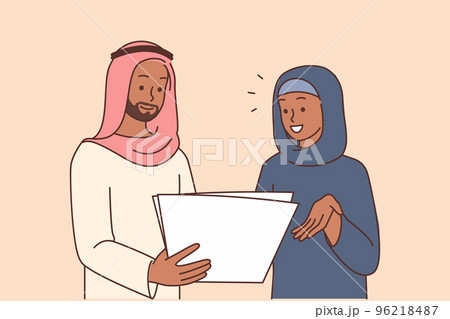 Smiling Arabic businesspeople discuss paperwork  96218487