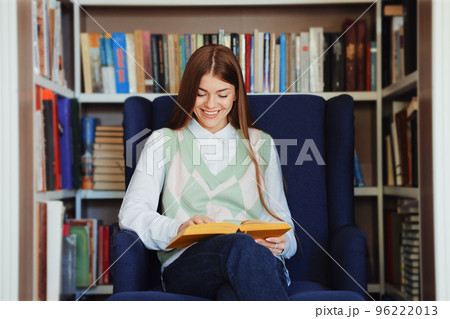 Woman reading book in bookstore Woman reading book in bookstore 96222013
