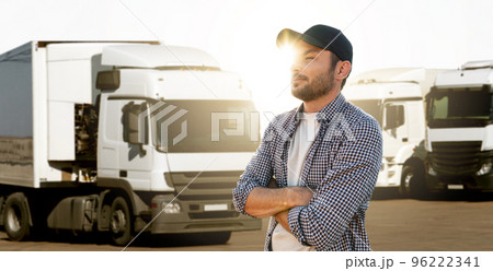 Truck driver in front of trucks 96222341