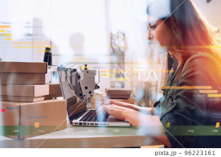 Seamstress works to new clothes ordered by internet client 96223161