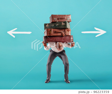 Man with a lot of luggages is confused about the right destination 96223359