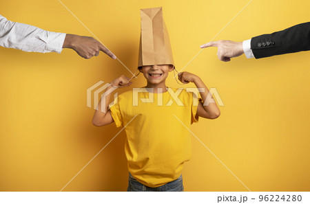 Child is scolded and he hides his head in a shopping bag Child is scolded and he hides his head in a shopping bag 96224280