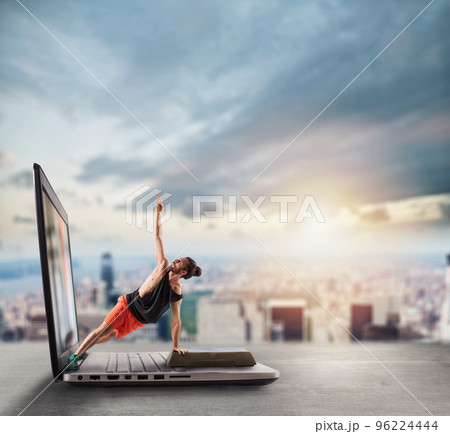 Personal trainer does gym lesson through internet and laptop Personal trainer does gym lesson through internet and laptop 96224444