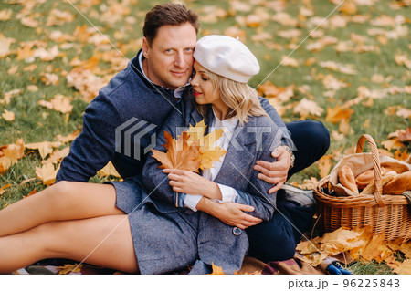 Happy couple enjoying golden autumn spring season in the park Happy couple enjoying golden autumn spring season in the park 96225843