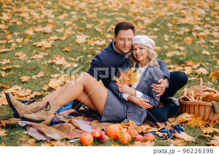 Happy couple enjoying golden autumn spring season in the park Happy couple enjoying golden autumn spring season in the park 96226396