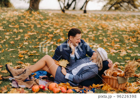 Happy couple enjoying golden autumn spring season in the park Happy couple enjoying golden autumn spring season in the park 96226398