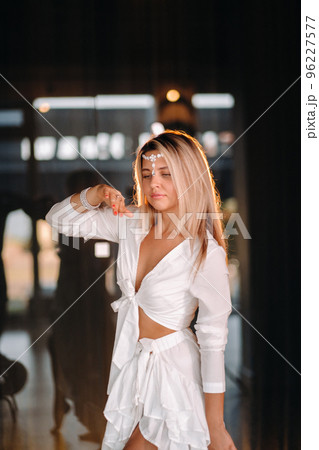 Beautiful smiling girl in a white dress dancing in the gym 96227577