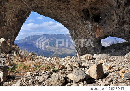 Rock arch and cave entrance 96229434