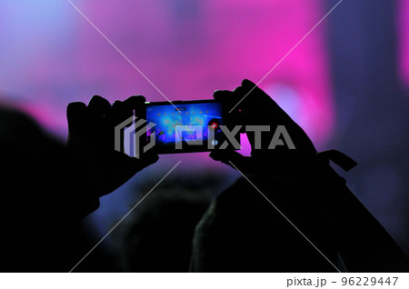 Crowd of people taking photos with smartphones at a concert Crowd of people taking photos with smartphones at a concert 96229447