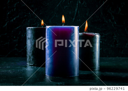 Burning candles on a dark background Burning candles on a dark background 96229741