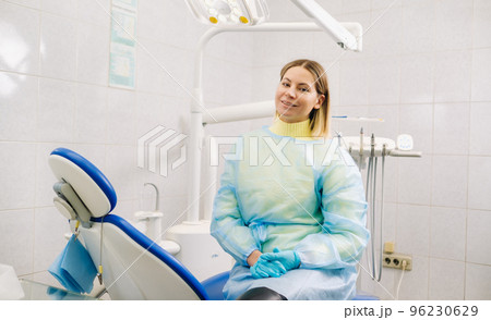 a female dentist sits in her dental office after work 96230629