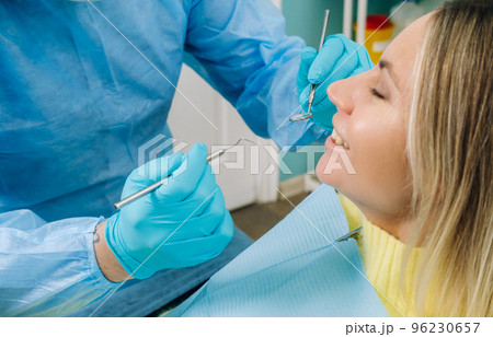 The patient treats her teeth at the dentist in the dental office . Dental fillings The patient treats her teeth at the dentist in the dental office . Dental fillings 96230657