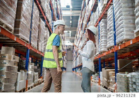 Joyous supervisor communicating with a warehouse worker 96231328