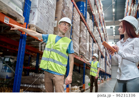Warehouse employees carrying out a racking system inspection 96231336
