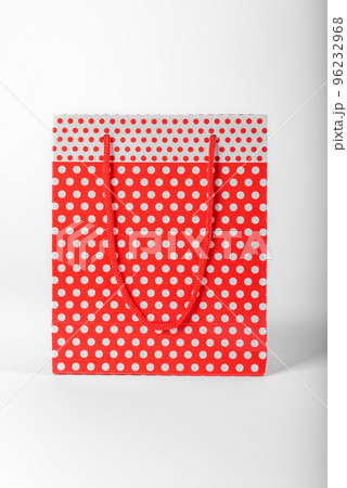 Bright red polka dot gift bag on a white background. 96232968