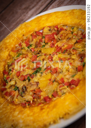 Recipe Omelette with peppers, onions, tomatoes, courgettes and coriander 96233192