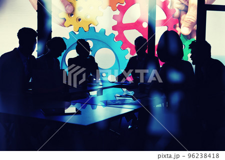 Business team connect pieces of gears. Teamwork, partnership and integration concept. double exposure with light effects Business team connect pieces of gears. Teamwork, partnership and integration concept. double exposure with light effects 96238418