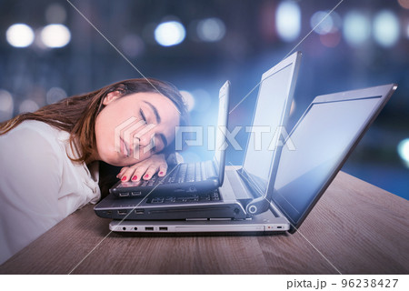 Businesswoman is tired due to too much work. Concept of stress and overwork Businesswoman is tired due to too much work. Concept of stress and overwork 96238427