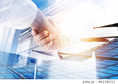 Two businessmen shake hands in agreement. Double exposure with light effect 96238532