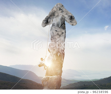 Businessman climbs a mountain shaped as an arrow. concept of statistics improvement 96238596