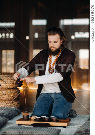 The tea master is preparing to hold a tea ceremony in the interior The tea master is preparing to hold a tea ceremony in the interior 96239076