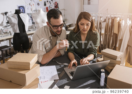 Seamstresses team ready to ship package to client with new clothes 96239740