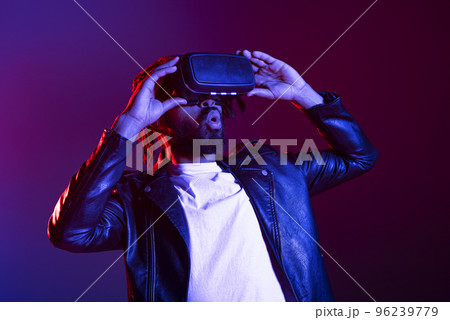 Man with VR glasses play with a virtual videogame 96239779