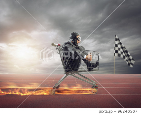 Businessman runs fast driving a cart on fire during a competition 96240507