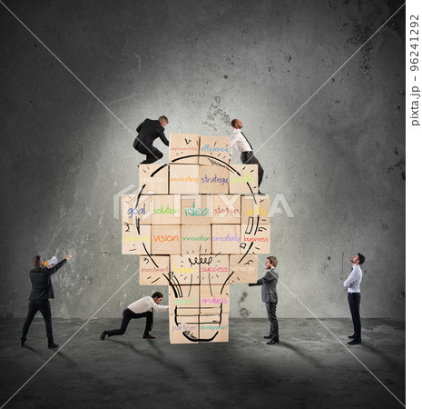 Building a new creative idea. Business person built together a big brick wall with drawn lightbulb 96241292