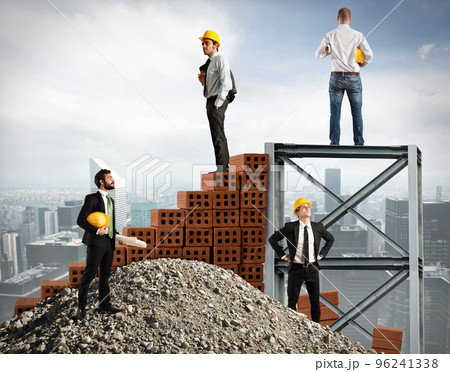 Businessmen work together to build a building 96241338