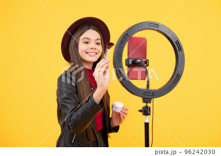 happy teen girl blogger use selfie led lamp and smartphone, makeup tutorial. happy teen girl blogger use selfie led lamp and smartphone, makeup tutorial. 96242030