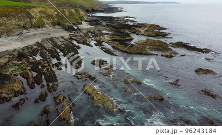 Bright rocky coast of the Atlantic Ocean in the south of Ireland. Beautiful Northern European nature. Aerial view of the rocky coastline. Aerial photo. Bright rocky coast of the Atlantic Ocean in the south of Ireland. Beautiful Northern European nature. Aerial view of the rocky coastline. Aerial photo. 96243184