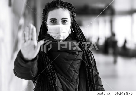 Girl in protective sterile medical mask on her face in quarantine city. Woman, wear face mask 96243876