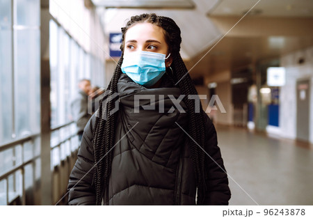 Girl in protective sterile medical mask on her face in quarantine city. Woman, wear face mask 96243878