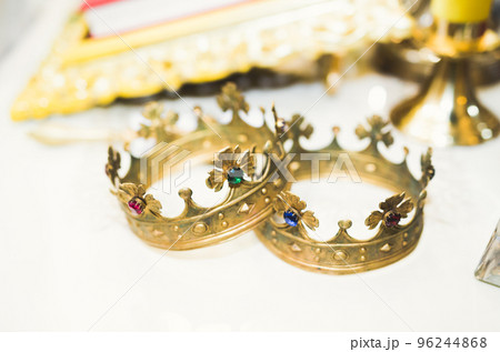 Golden crowns lying on the table in church Golden crowns lying on the table in church 96244868